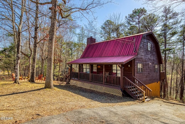 1785 Blue Ridge Rd, Sevierville, TN 37876 - view of front facade with a porch, metal roof, a chimney, and a gambrel roof