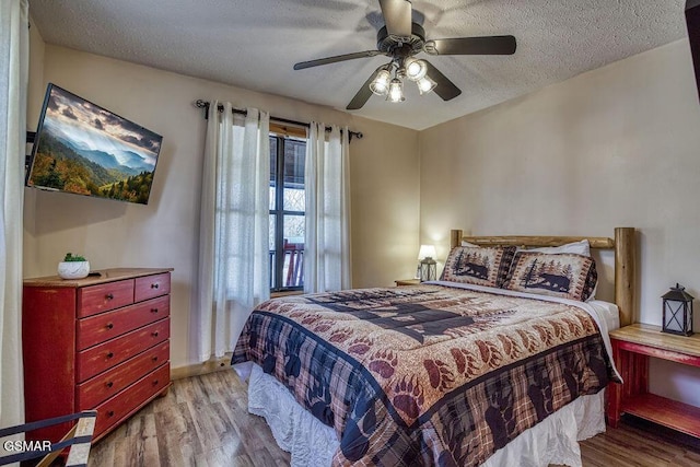 1785 Blue Ridge Rd, Sevierville, TN 37876 - bedroom featuring wood finished floors, a textured ceiling, ceiling fan, and baseboards