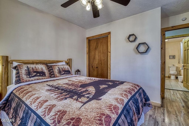 1785 Blue Ridge Rd, Sevierville, TN 37876 - bedroom featuring a textured ceiling, wood finished floors, a ceiling fan, baseboards, and connected bathroom