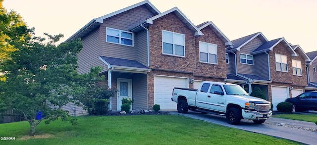 1003 Woullard Way Unit 1, Sevierville, TN 37876 - view of front of house with an attached garage, stone siding, a front yard, and driveway