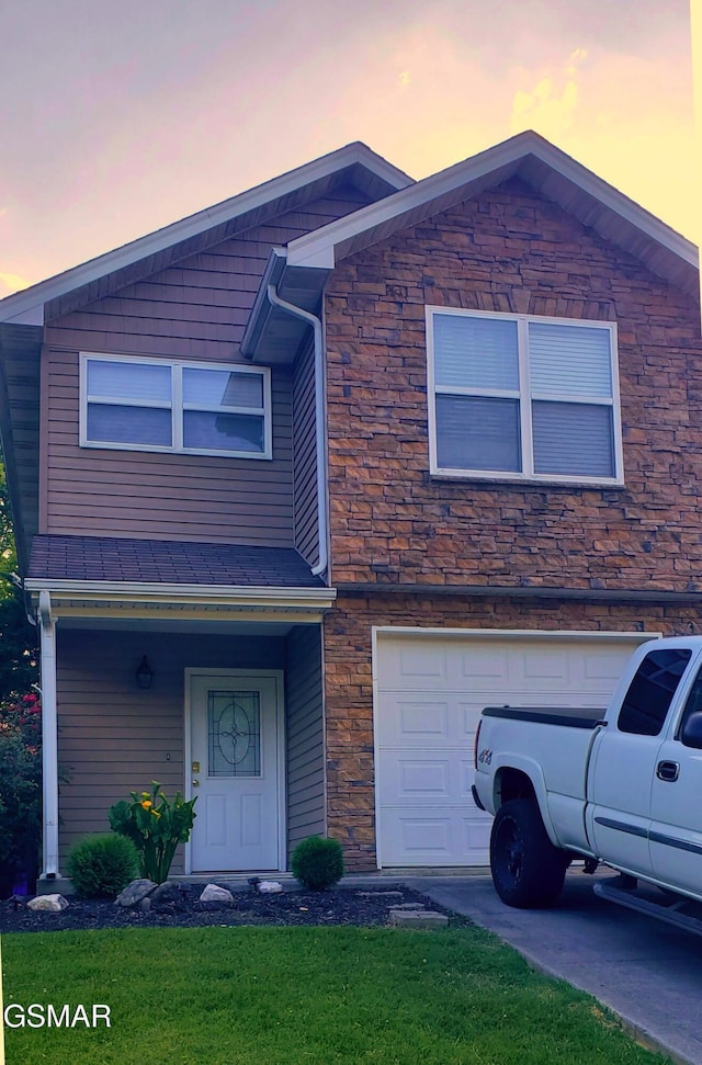 1003 Woullard Way Unit 1, Sevierville, TN 37876 - view of front facade featuring stone siding, an attached garage, and a lawn