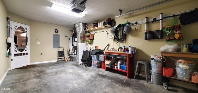 1003 Woullard Way Unit 1, Sevierville, TN 37876 - garage with a garage door opener, electric panel, gas water heater, and a workshop area