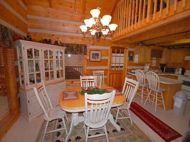 dining space with a notable chandelier and a towering ceiling