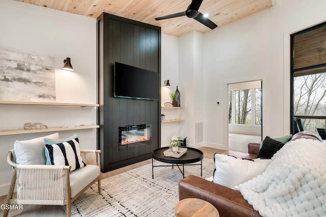- Chinquapin Drive, Sevierville, TN 37862 - living area featuring wood ceiling, a ceiling fan, a fireplace, baseboards, and light wood finished floors
