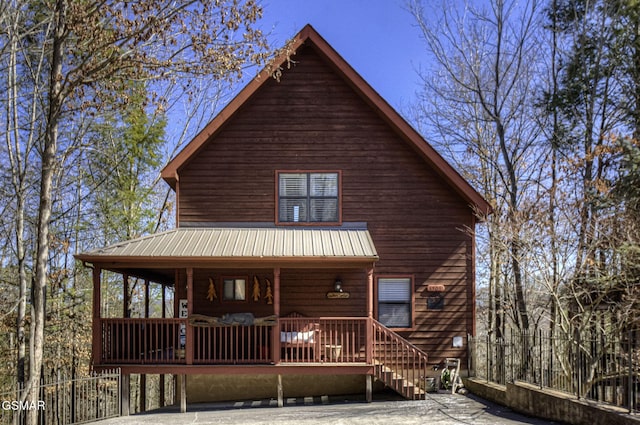 view of front of property with covered porch and metal roof