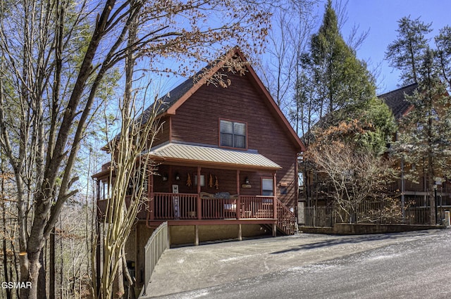 view of front of home featuring covered porch and metal roof