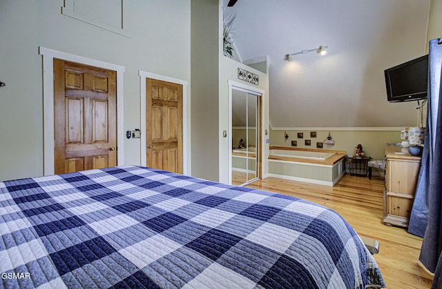 unfurnished bedroom with light wood-style floors, a closet, and a high ceiling