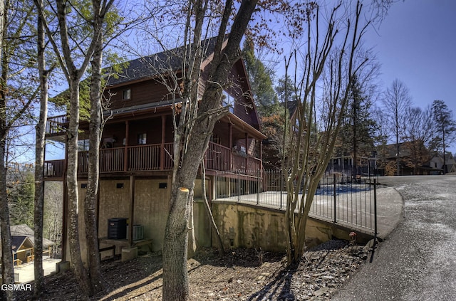 rear view of house featuring central AC