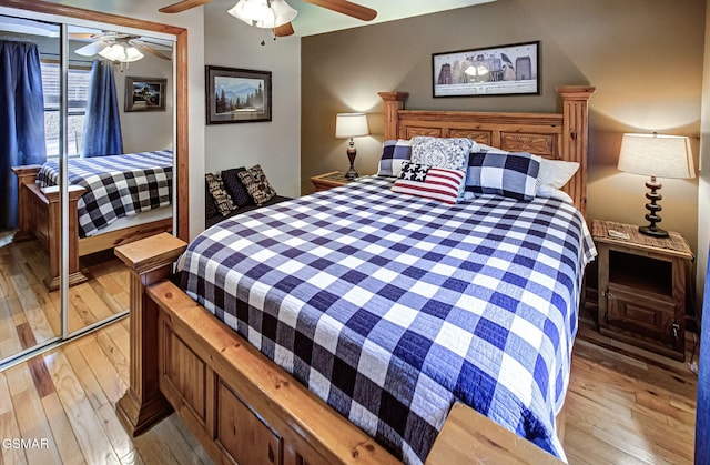 bedroom featuring a ceiling fan, a closet, and light wood-style flooring