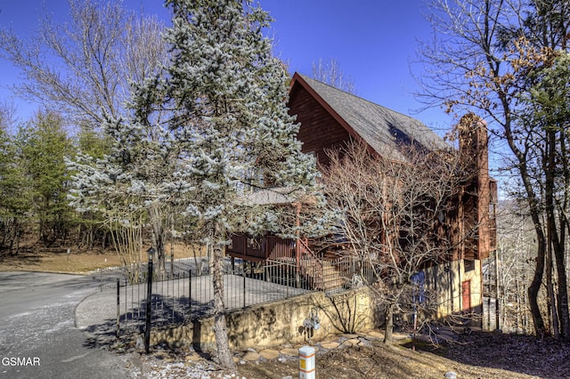 view of property exterior featuring fence