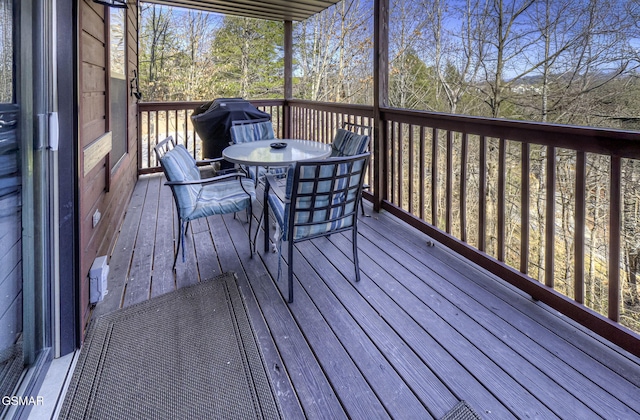 deck with outdoor dining area and area for grilling