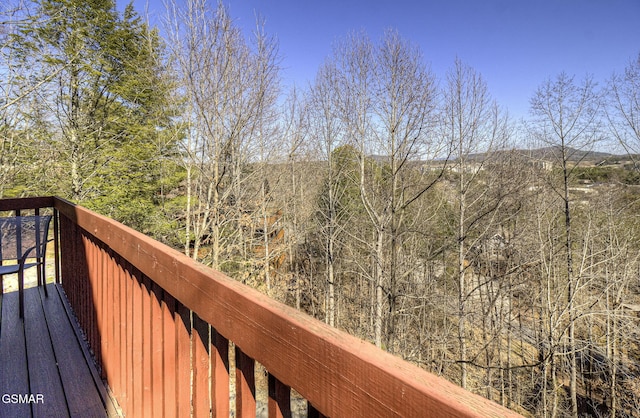 wooden terrace with a wooded view