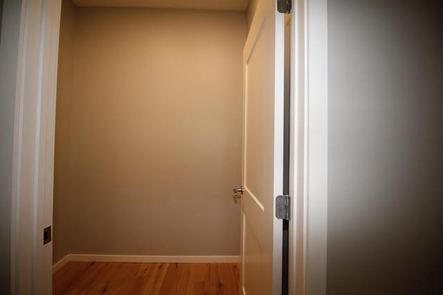 corridor with light hardwood / wood-style floors