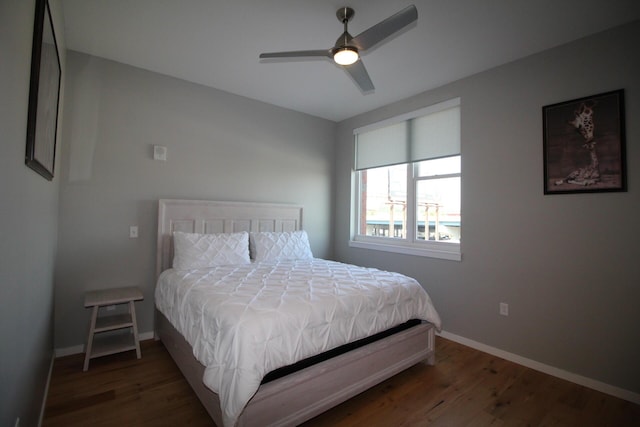 bedroom with ceiling fan and dark hardwood / wood-style floors