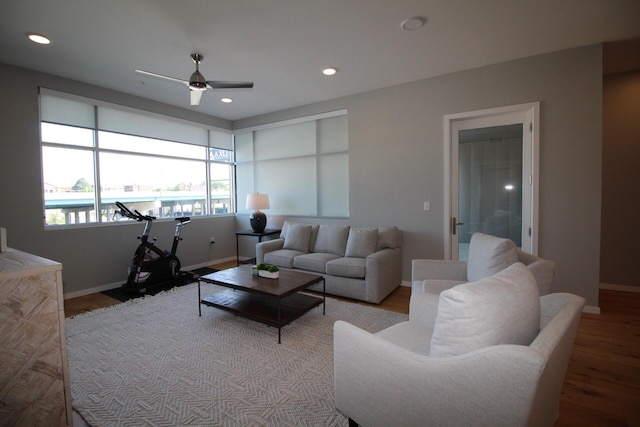 living room featuring ceiling fan and light wood-type flooring