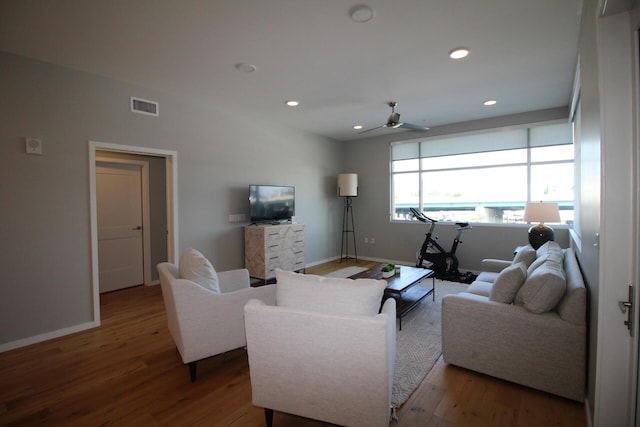 living room featuring hardwood / wood-style flooring and ceiling fan