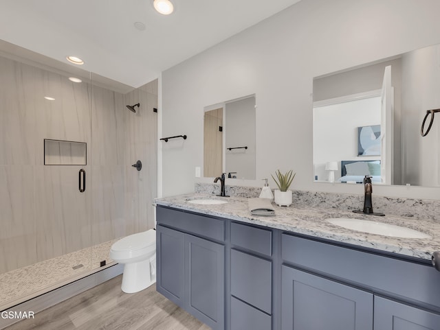 3141 Teaster Ln Unit 2, Pigeon Forge, TN 37863 - bathroom featuring a shower stall, double vanity, wood finished floors, and recessed lighting