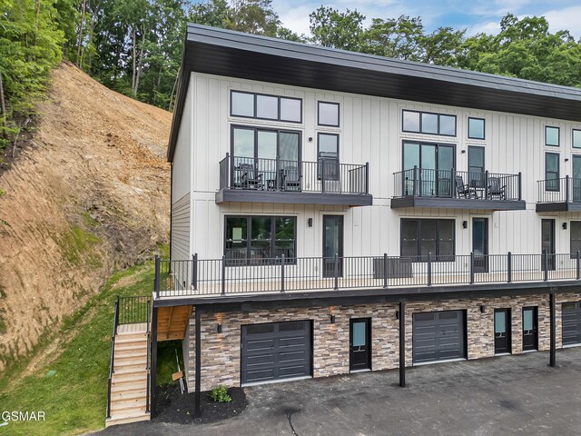 3141 Teaster Ln Unit 2, Pigeon Forge, TN 37863 - view of building exterior with a garage, stairs, and driveway