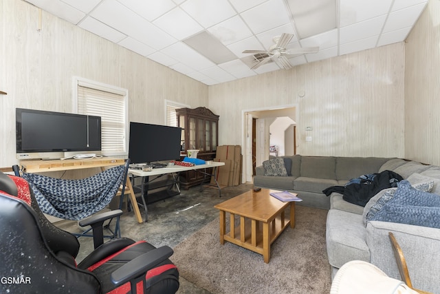 living room with a paneled ceiling and ceiling fan