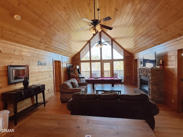 living room featuring wood walls, ceiling fan, billiards, and vaulted ceiling