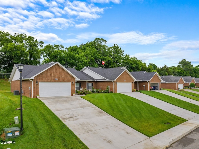 1032 Patriots Dr, Dandridge, TN 37725 - ranch-style house with brick siding, a front yard, and driveway