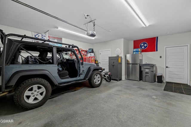 1032 Patriots Dr, Dandridge, TN 37725 - garage featuring freestanding refrigerator and a garage door opener