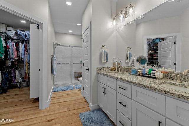 1032 Patriots Dr, Dandridge, TN 37725 - full bath with double vanity, wood finished floors, a stall shower, a walk in closet, and recessed lighting