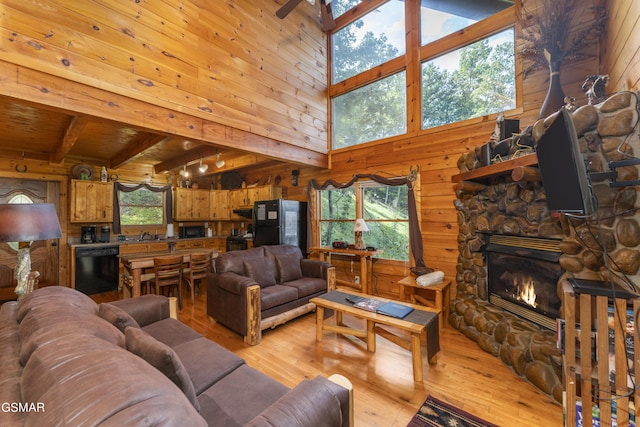 1814 Rhododendron Ln, Sevierville, TN 37876 - living room featuring a fireplace, ceiling fan, wooden ceiling, beamed ceiling, and light hardwood / wood-style floors
