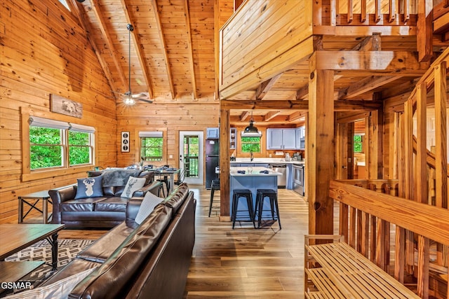 308 Brown Wren Way, Gatlinburg, TN 37738 - living room with light wood-style floors, wooden walls, a wooden ceiling with exposed beams, and high vaulted ceiling