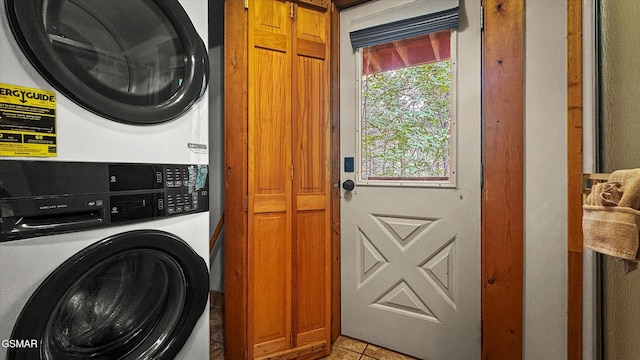 308 Brown Wren Way, Gatlinburg, TN 37738 - laundry area with stacked washer / drying machine, cabinet space, and light tile patterned flooring