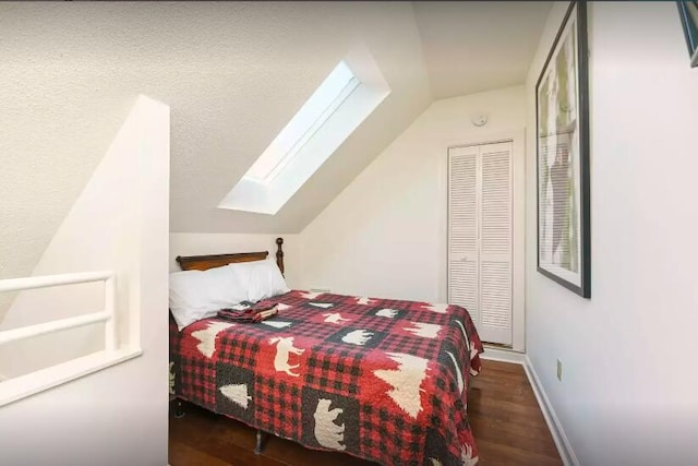 bedroom with dark hardwood / wood-style floors and vaulted ceiling