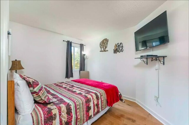 bedroom featuring wood-type flooring