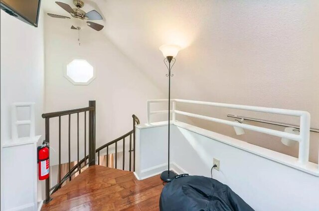 interior space with hardwood / wood-style floors, ceiling fan, and vaulted ceiling