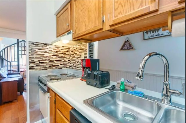 kitchen featuring white range with electric cooktop, sink, hardwood / wood-style flooring, decorative backsplash, and range hood