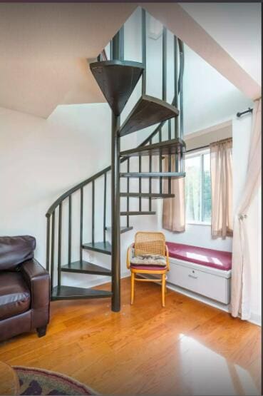 stairs featuring hardwood / wood-style flooring