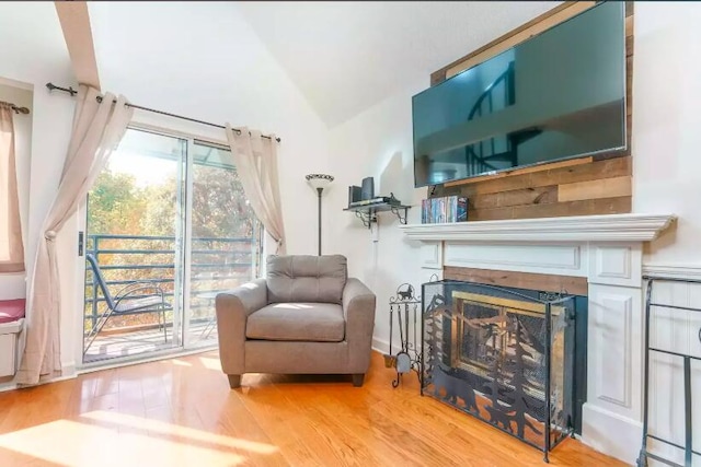 sitting room with hardwood / wood-style flooring and lofted ceiling