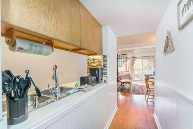 kitchen featuring light brown cabinetry and hardwood / wood-style floors