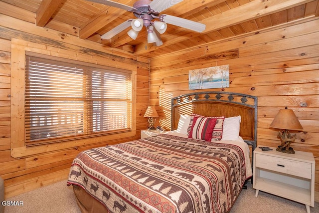 carpeted bedroom featuring beam ceiling, wooden walls, wooden ceiling, and ceiling fan