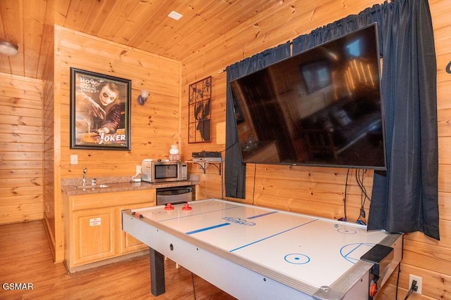 playroom with wooden walls, sink, light hardwood / wood-style flooring, and wooden ceiling