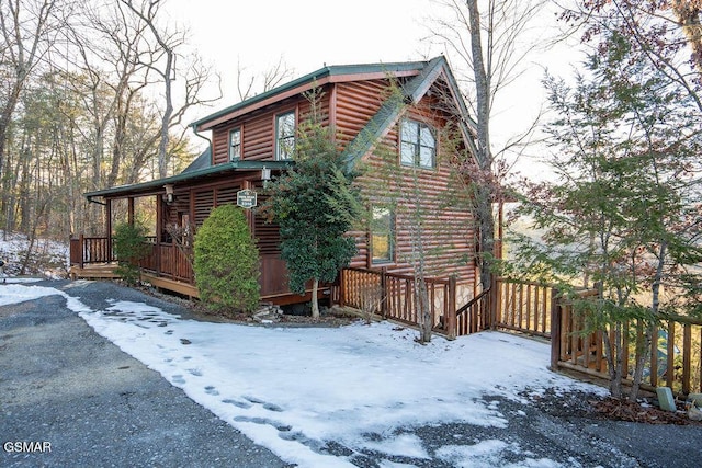 view of snowy exterior with a porch