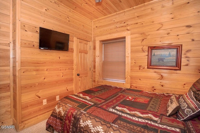 bedroom featuring wooden walls, wooden ceiling, and carpet flooring