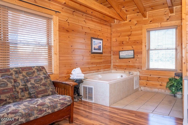 bathroom with a tub to relax in, wood-type flooring, wooden ceiling, and vaulted ceiling with beams