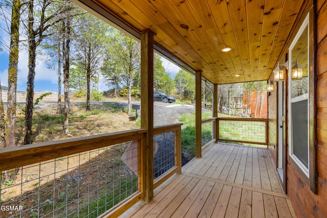 unfurnished sunroom with a wealth of natural light and wooden ceiling