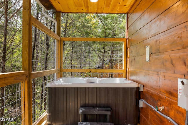 sunroom with wood ceiling and a jacuzzi