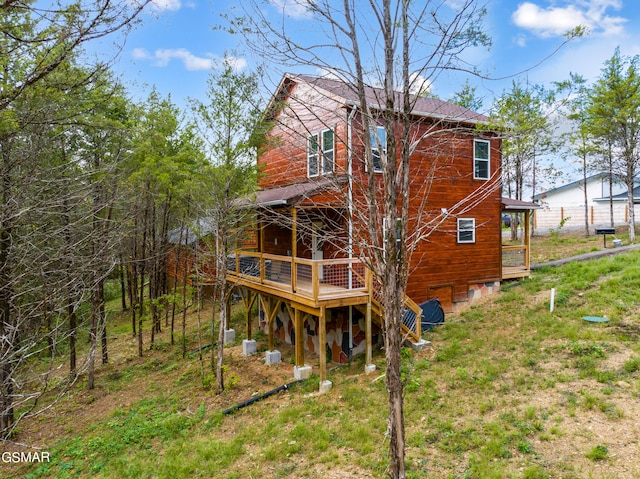 back of property featuring a wooden deck