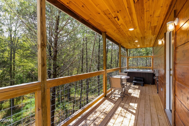 wooden deck featuring central AC and a hot tub