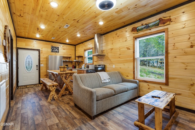 living room featuring wood-type flooring, plenty of natural light, wood ceiling, and wood walls