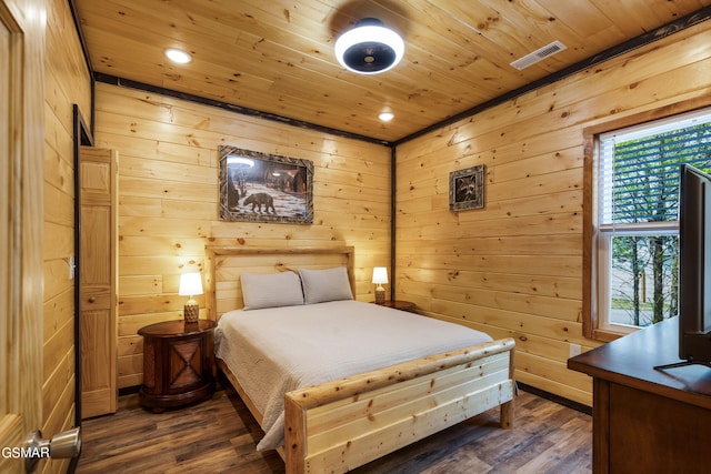 bedroom featuring wooden ceiling, dark wood-type flooring, and wooden walls