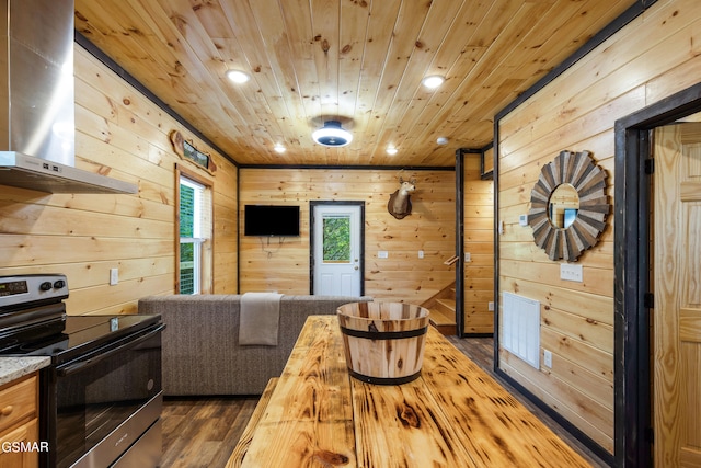 living room featuring wood walls, dark wood-type flooring, and wooden ceiling