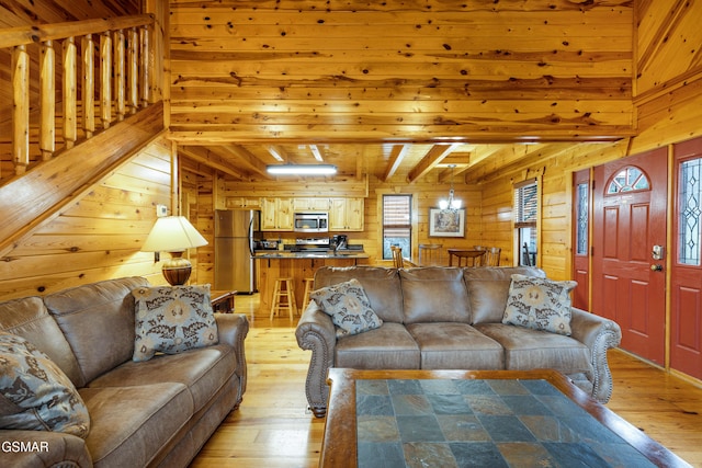 living room with wooden ceiling, wooden walls, and light hardwood / wood-style flooring